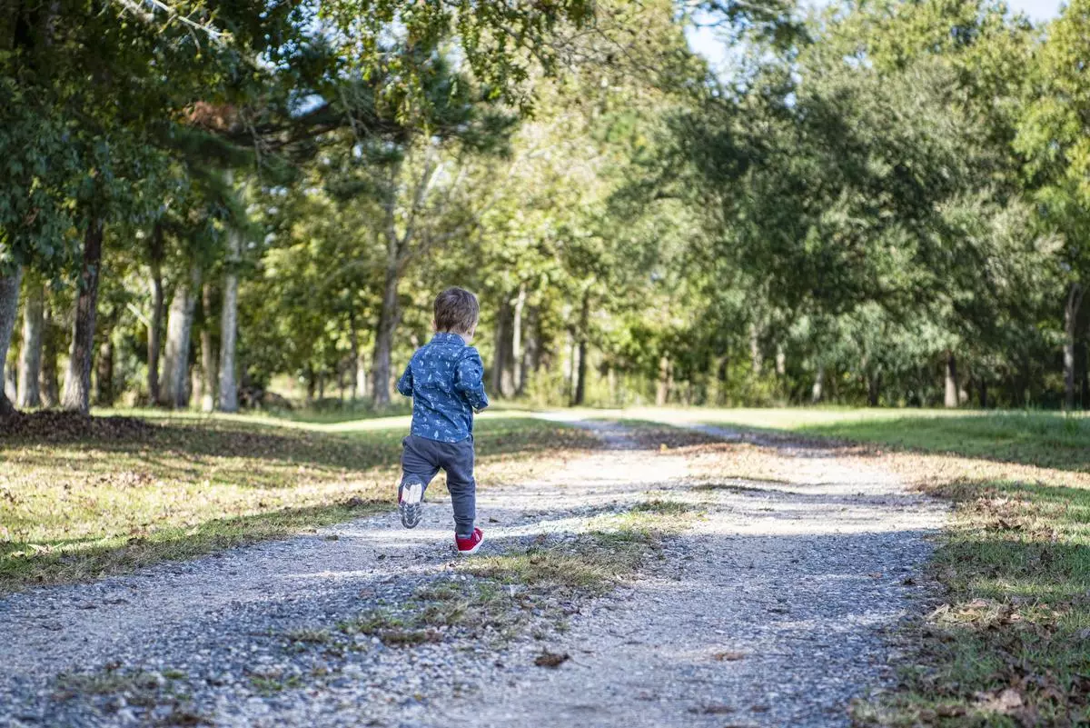 Kid running down trail